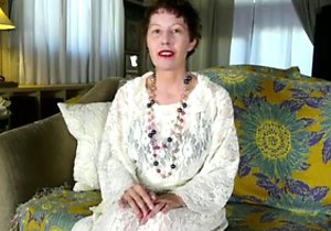 Mature brunette fucking herself on the sofa